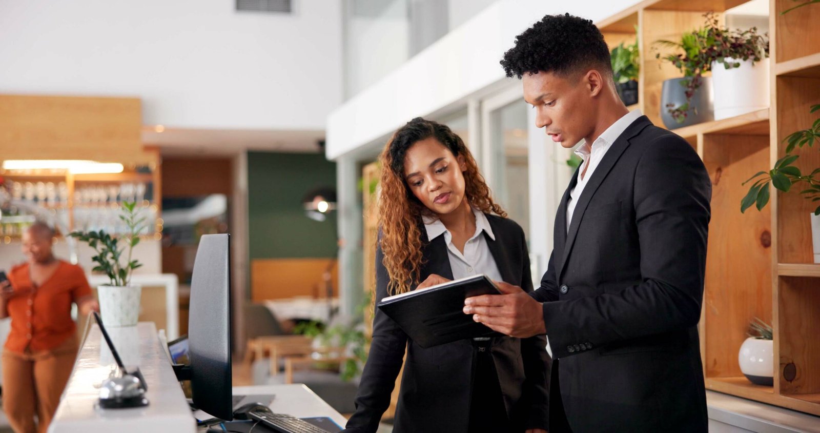 Reception, employees and tablet with teamwork, hotel and accommodation with cooperation. Coworkers, hospitality and service with tech, internet and digital app for schedule and reservation for lodge.